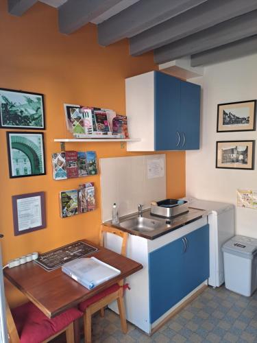 a small kitchen with a sink and a table at Chez Robins in Trie-Château