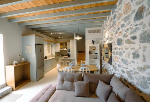 a living room with a couch and a stone wall at Villa Calliope in Kalymnos