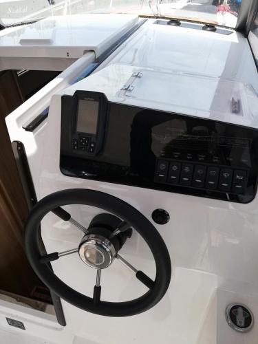a boat with a phone and a steering wheel at Letnisko BAJKA in Iława