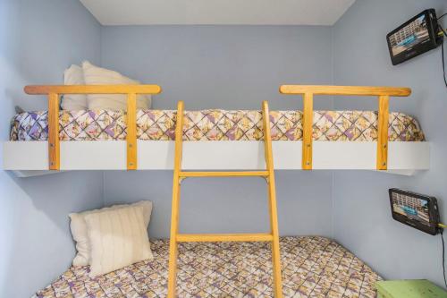 two bunk beds in a small room with at The Dunes 502 by Vacation Homes Collection in Gulf Shores