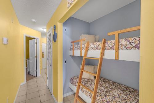 a room with two bunk beds and a hallway at The Dunes 502 by Vacation Homes Collection in Gulf Shores