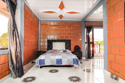a bedroom with a brick wall and a bed in a room at Finca Villa Hermosa in Alcalá