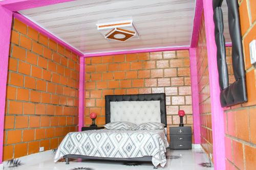 a brick walled bedroom with a bed in a room at Finca Villa Hermosa in Alcalá