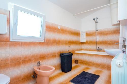 a bathroom with a toilet and a sink and a tub at Apartment and Rooms Dalmatiko in Vodice