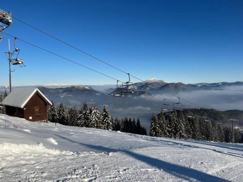 a ski lift on top of a snow covered mountain at Chalet Pod Brdom - Apartments in Ružomberok