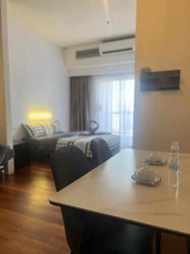 a living room with a table and a bed at Resort Suites By Newcityhome in Petaling Jaya
