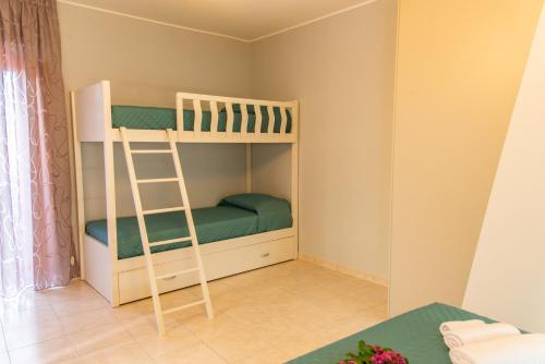 a bunk bed with a ladder in a room at B&B al Vico Pepe in Castelmezzano
