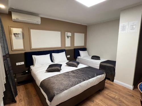 Postel nebo postele na pokoji v ubytování Amber Hotel