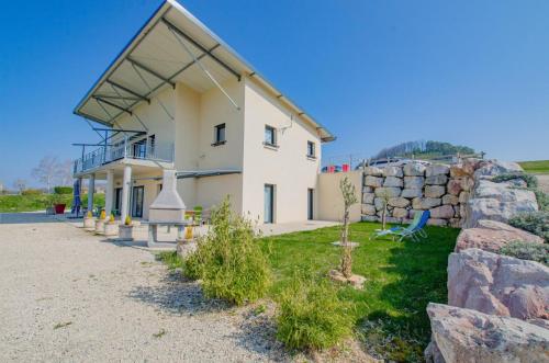 a large white house with a stone wall at Le grand clos in Meurville
