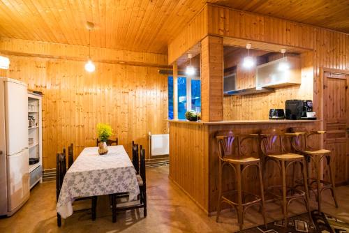 Myza Kayve的住宿－Dzintari IR，厨房配有桌椅和冰箱。