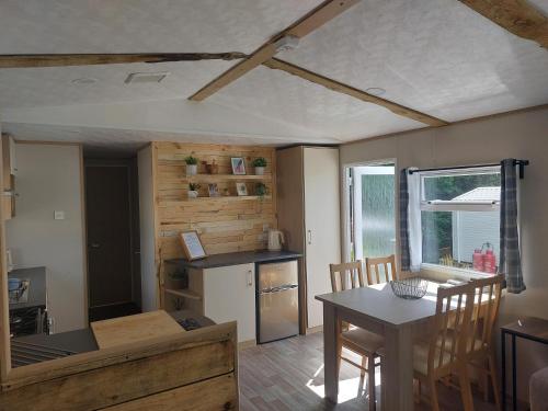 a kitchen and dining room with a table and chairs at The Secret Wood in Swarland