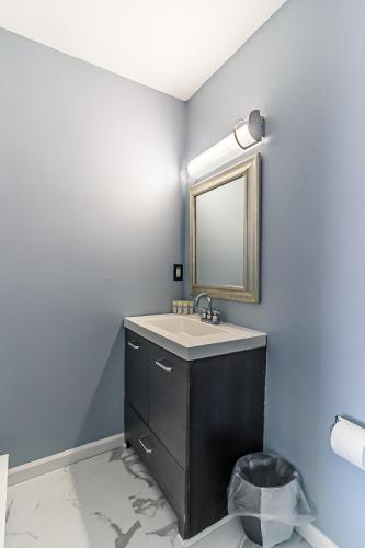 a bathroom with a sink and a mirror at Boardwalk Hotel Charlee & Apartments Beach Hotel Oceanfront in Seaside Heights