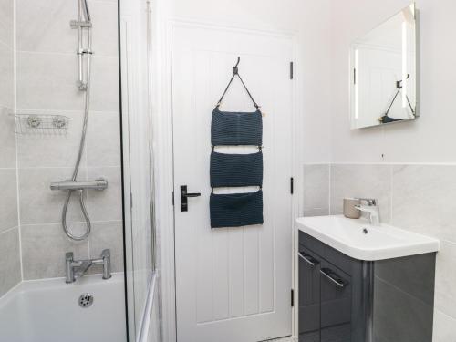 a bathroom with a shower and a sink and a mirror at The Mill in Blandford Forum