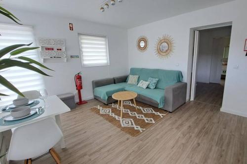 a living room with a couch and a table at Villa de Bruma Faial da Terra in Faial da Terra