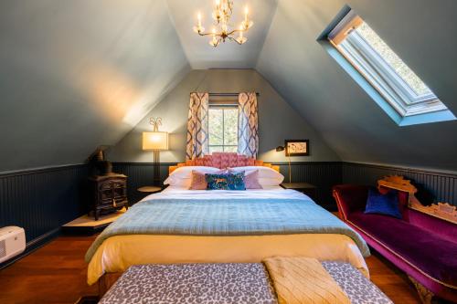 a bedroom with a large bed in a attic at The Matriarch- Downtown Ashland, OR in Ashland