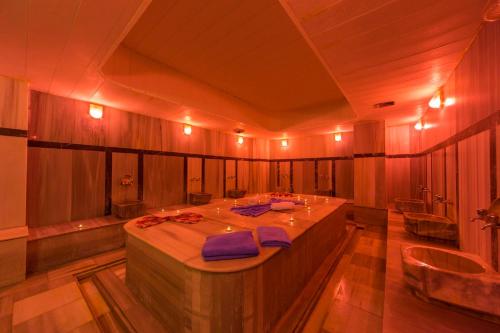 a large bathroom with a large table and a tub at Club Sun Paradise Hotel - All Inclusive in Avsallar