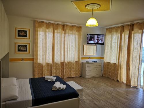 a bedroom with a bed and a tv in it at La Casa di Alfonso in Marina di Camerota