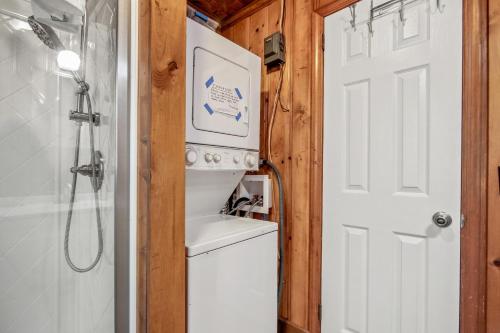 a bathroom with a washer and dryer next to a door at House 314 in Myrtle Beach