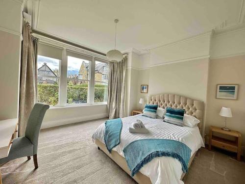 a bedroom with a bed and a large window at Garden Apartment, Central Harrogate with parking in Harrogate