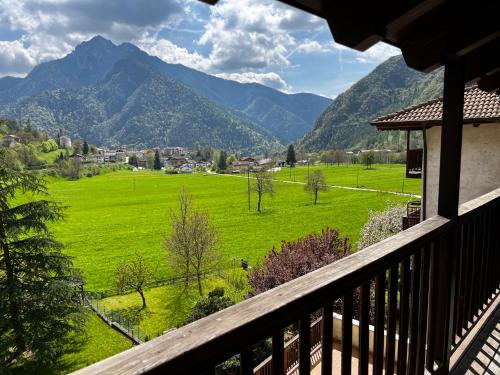 a balcony with a view of a green field and mountains at Casa Miravalle Mountain Apartments in Enguiso