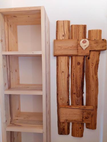 a wooden cross hanging on a wall at Tristner Appart in Schwendau