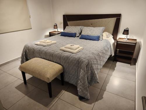 a bedroom with a bed with two towels on it at Apartamento Deluxe Senderos del Vino II, desayuno Opcional in Mendoza