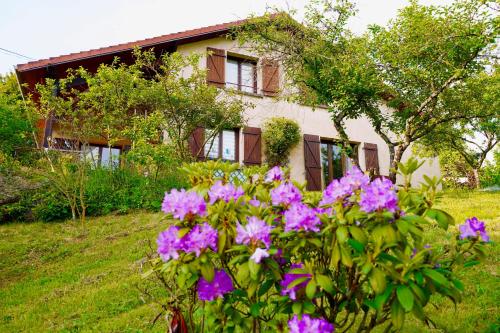 a house with purple flowers in front of it at Maison à la campagne entre Nancy et Pont-à-Mousson in Malleloy
