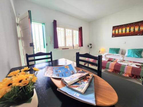 a dining room with a table and a bed at COZY STUDIO CLOSE TO THE BEACH! in Santa Maria