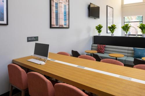 a conference room with a table with a laptop on it at Holiday Inn Victoria - Elk Lake by IHG in Victoria