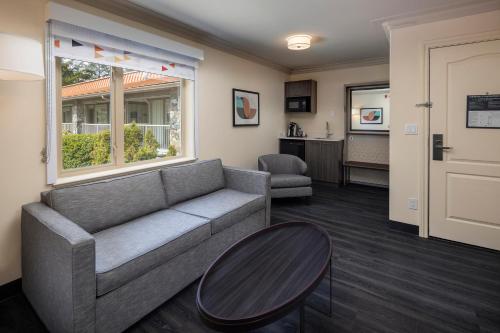 a living room with a couch and a table at Holiday Inn Victoria - Elk Lake by IHG in Victoria