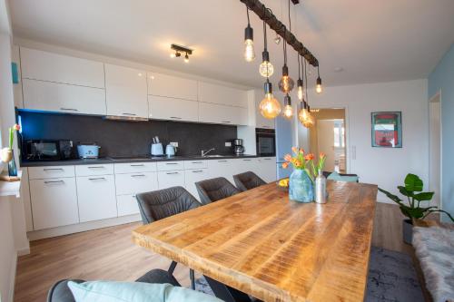 a kitchen with a wooden table in a room at City-House-Achern in Achern