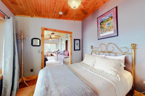 a bedroom with a white bed and a mirror at Hazen's Hideaway in North Hero