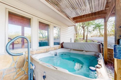 a hot tub in a room with windows at Lakeview Lure in Oakland
