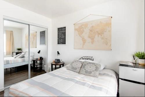 a bedroom with a bed and a map on the wall at Comfy Private ROOM in San Jose