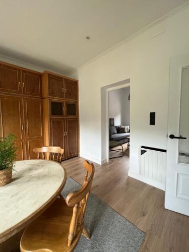 a living room with a wooden table and chairs at Mountain View Apartment in Mieres