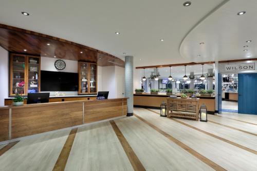a lobby with a waiting area with a large tv at Meliá Orlando Celebration in Orlando