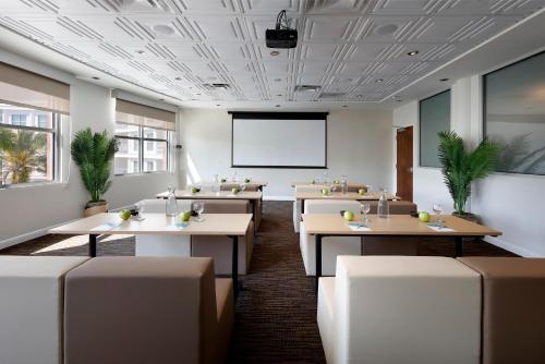 a conference room with tables and a projector screen at Meliá Orlando Celebration in Orlando