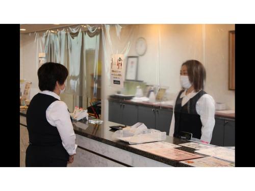 two women standing in a kitchen wearing masks at Blancart Misasa - Vacation STAY 14624v in Misasa