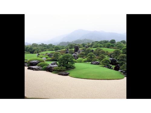 a picture of a golf course with trees and bushes at Blancart Misasa - Vacation STAY 14628v in Misasa