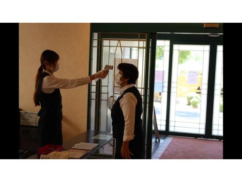 a man and a woman standing in a room at Blancart Misasa - Vacation STAY 14614v in Misasa