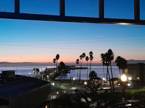 a view of a marina at night with palm trees at Howard Johnson by Wyndham Santa Cruz in Santa Cruz