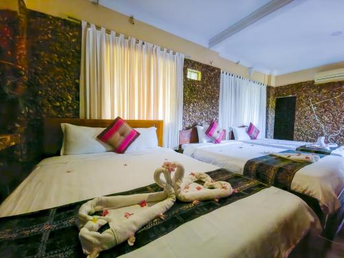 a bedroom with two beds with dolls on them at Kep Villa Hill Guest House 1 in Kep
