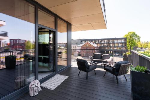 a balcony with chairs and a couch on a building at Liine apartment 3027 in Pärnu