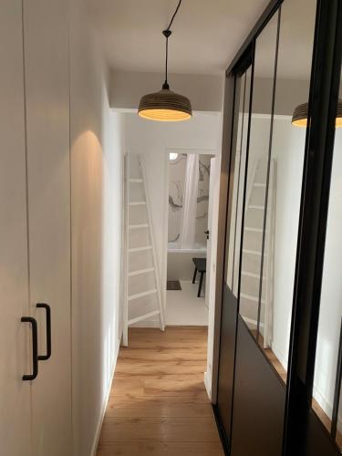 a hallway with a door and a room with stairs at Appartement d'exception, vue Saint-Tropez in Saint-Tropez