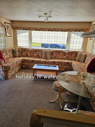 a living room with a couch and a car in the window at Static 19 in Llandysul
