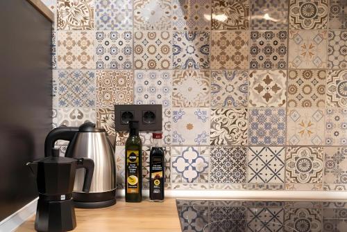 a kitchen counter with a coffee maker and a tile wall at Bilbao Urban City in Bilbao