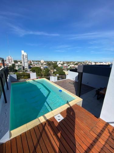 a swimming pool on the roof of a building at Dpto Temporario Corrientes in Corrientes