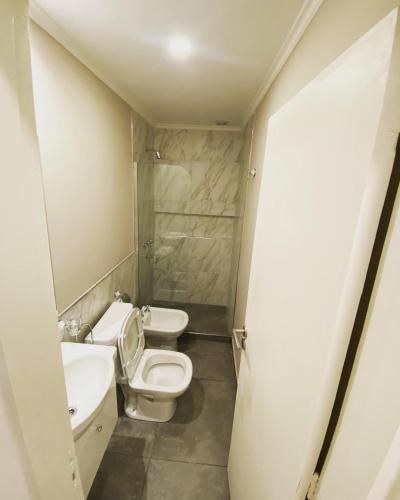 a bathroom with two toilets and a sink at Dpto Temporario Corrientes in Corrientes