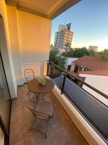 a balcony with a table and chairs on a building at Dpto Temporario Corrientes in Corrientes