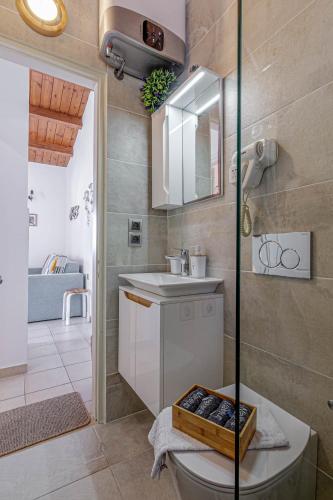 a bathroom with a sink and a toilet in a room at Glyfada Corfu Sea blue 137 in Glyfada